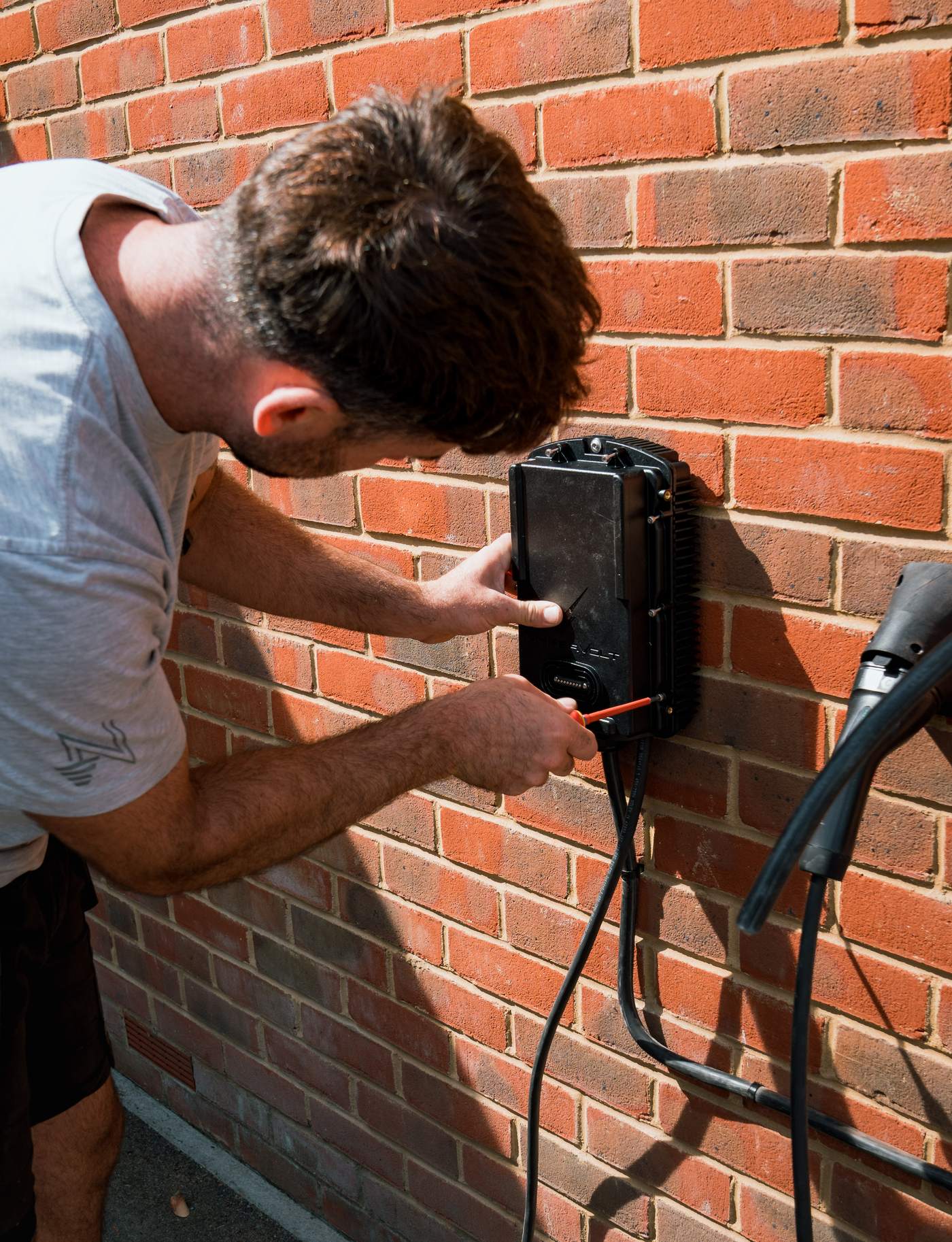 Tom fitting the cover onto a Hypervolt charger