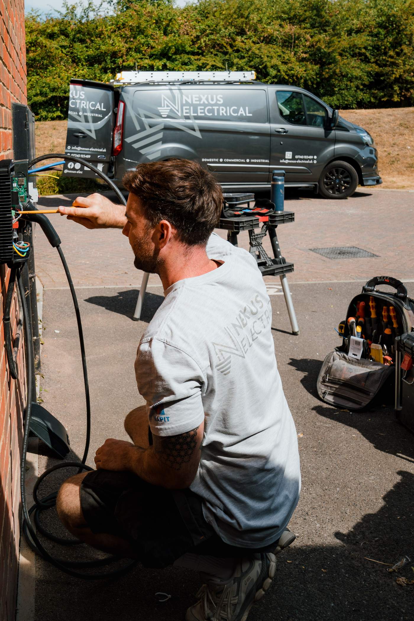 Tom routing the charger cable with the Nexus van behind