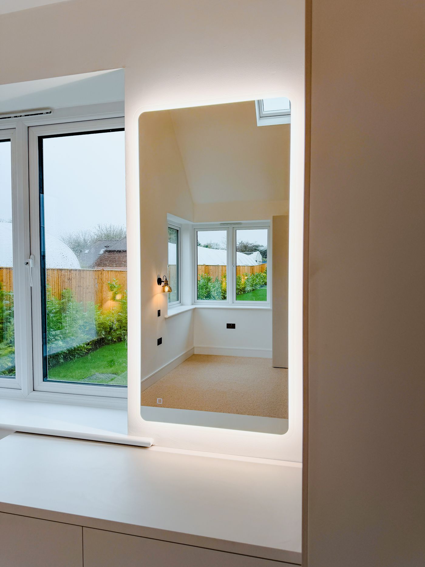 Illuminated full length mirror in a bedroom