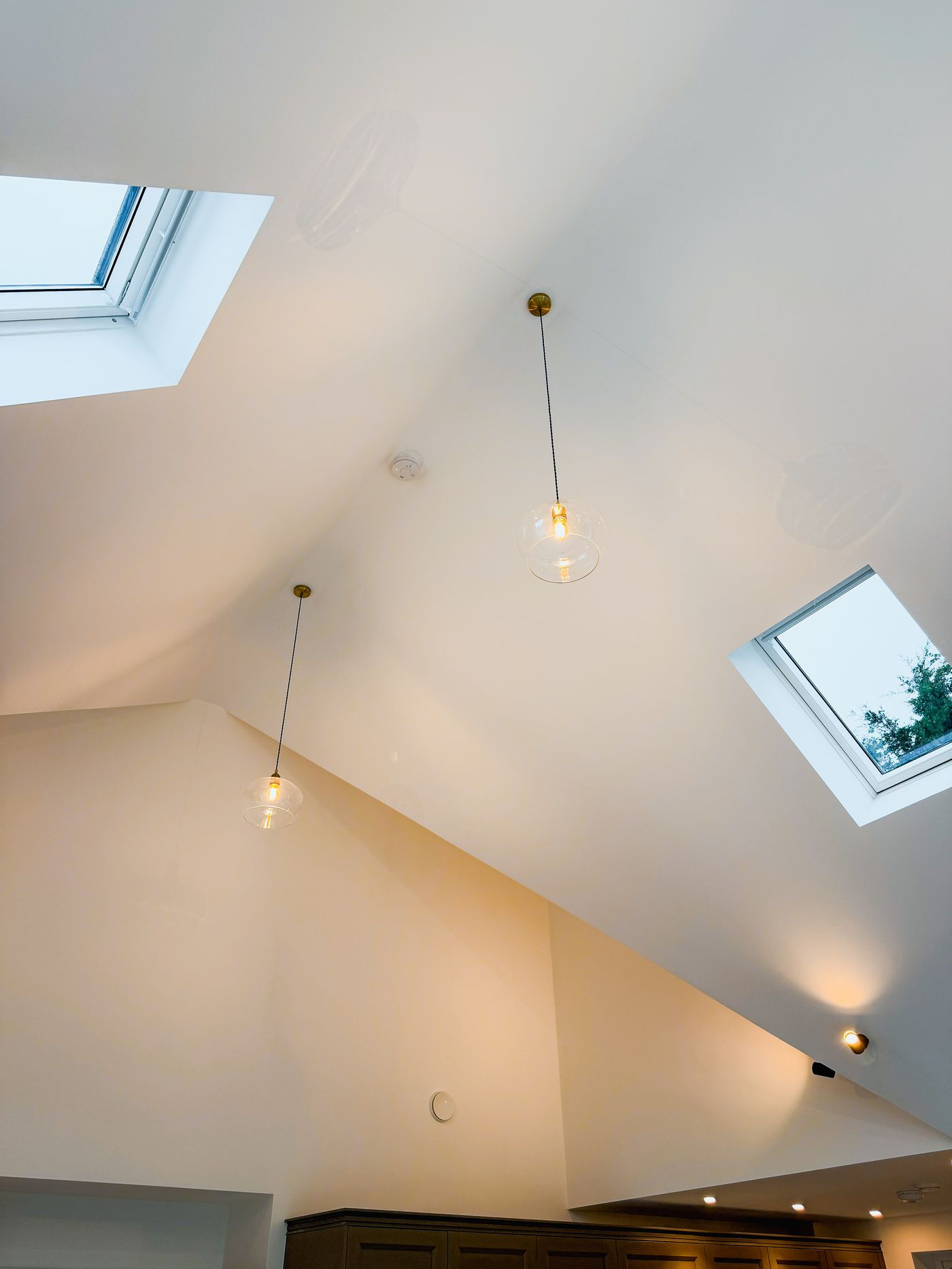 Pendant lights and wall lights in a vaulted room